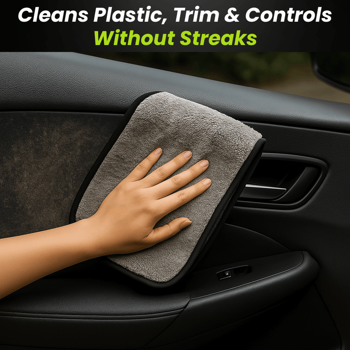 Hand wiping a car door panel with a gray microfiber towel