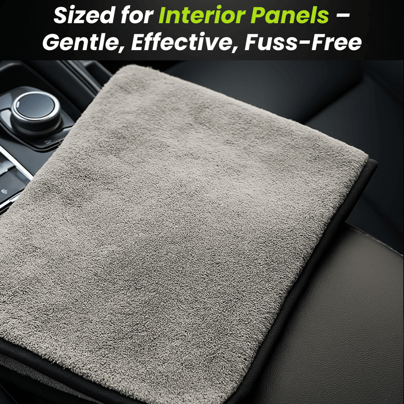 Gray microfiber car drying towel resting on a black car interior panel
